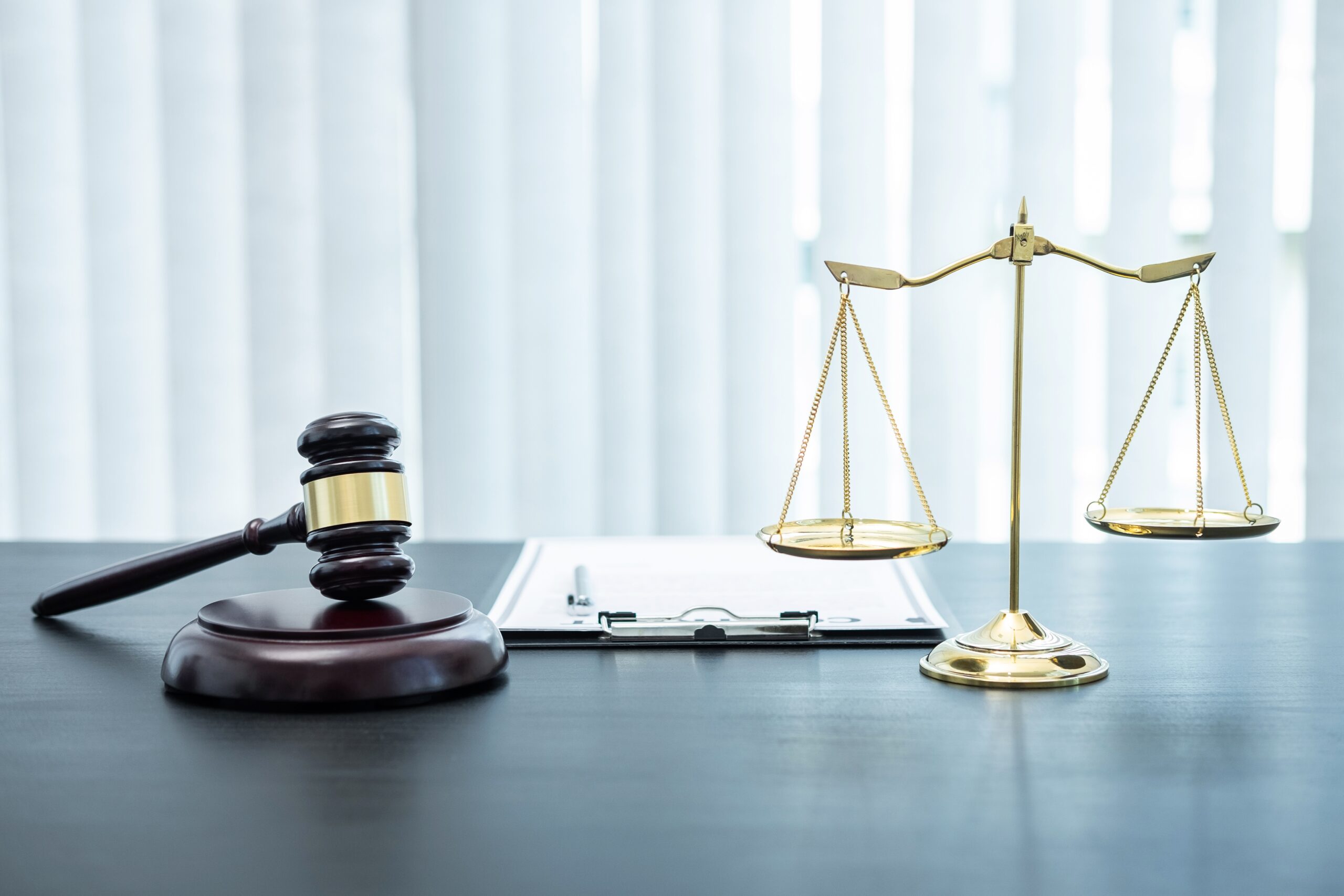 Judge gavel with Justice at law firm in background with legal ca